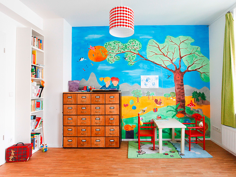 Kinderzimmer mit kreativer individueller Wandgestaltung in Kall, harmonischen Farben, verspielten Motiven und gemütlicher Einrichtung für eine freundliche Wohnatmosphäre.